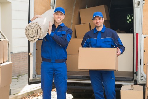 Helpers moving boxes from a Notting Hill flat with stairs