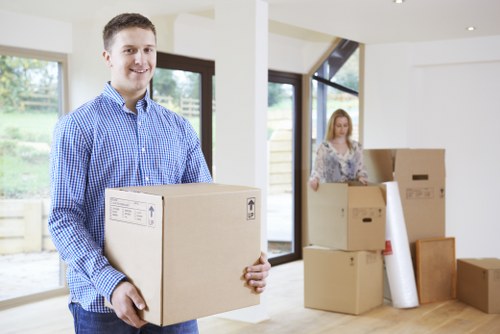 Packed boxes and furniture being loaded into a removal truck