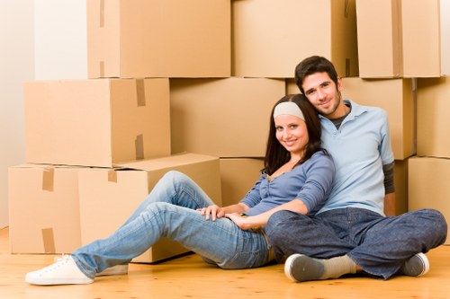 Professional movers handling furniture in a west London residential property