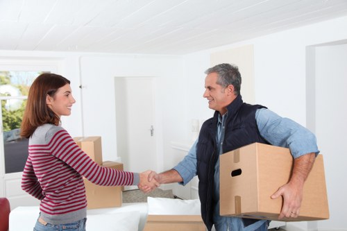 Packed moving boxes and furniture ready for transport in Notting Hill