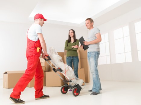 Professional movers handling furniture in a period property in Notting Hill