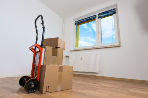 Removal crew carrying items through a Notting Hill staircase